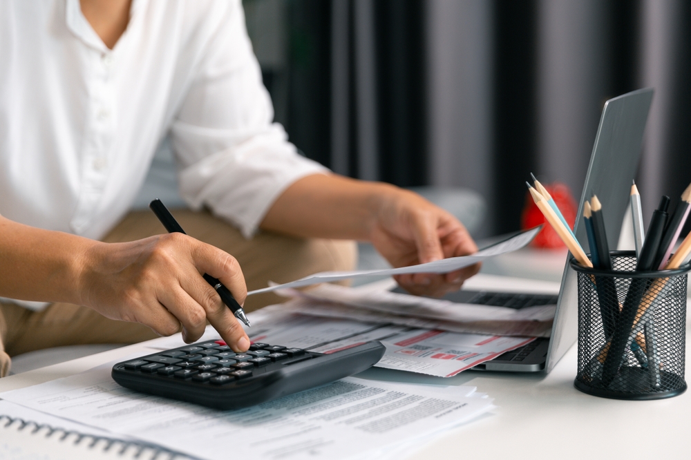 Inspecting finance documents business owner ensured all income and tax records were accurate